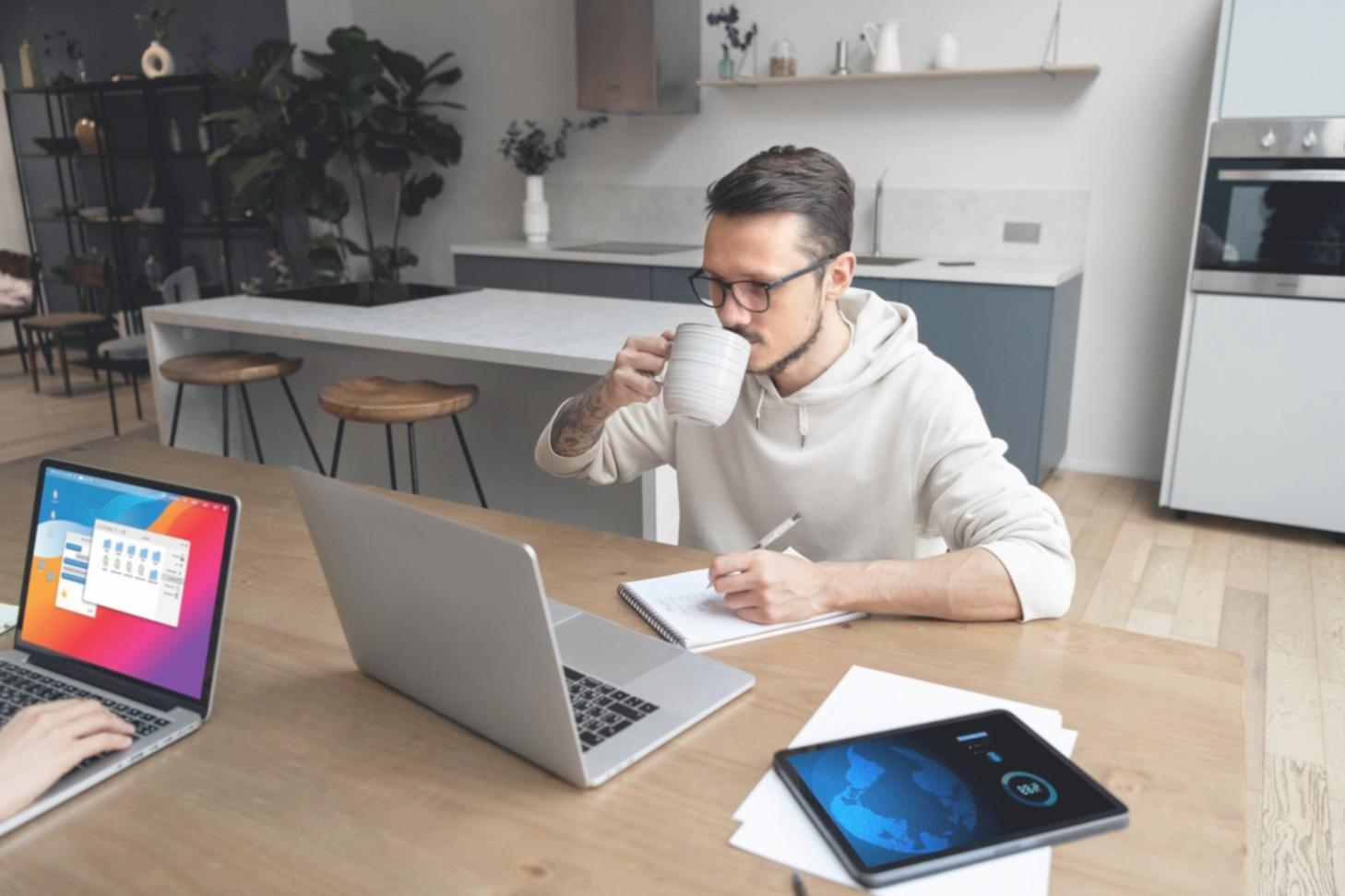 Students collaborating on a web development project with laptops and planning materials